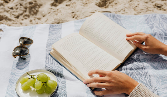 Foto di persona che legge in spiaggia
